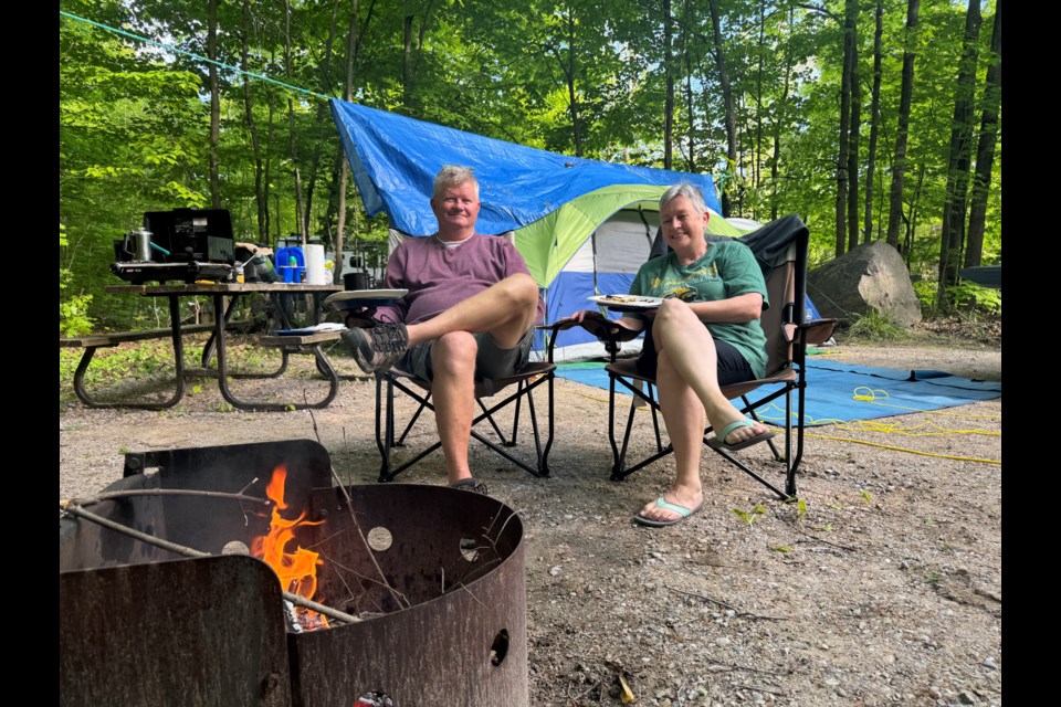Dan and Glenna Rivett, from the Smiths Falls, area enjoyed breakfast by the campfire at Bass Lake Provincial Park on Saturday.