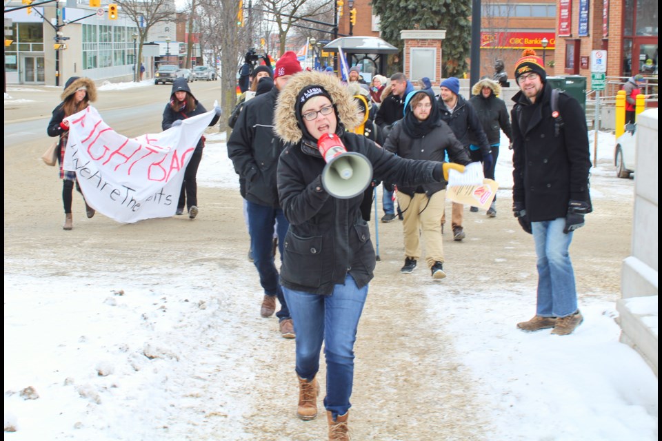 Theresa VandeBurgt, vice-president of the Lakehead University Student Union in Orillia, leads demonstrators on a march to Simcoe North MPP Jill Dunlop's constituency office Tuesday. Nathan Taylor/OrilliaMatters