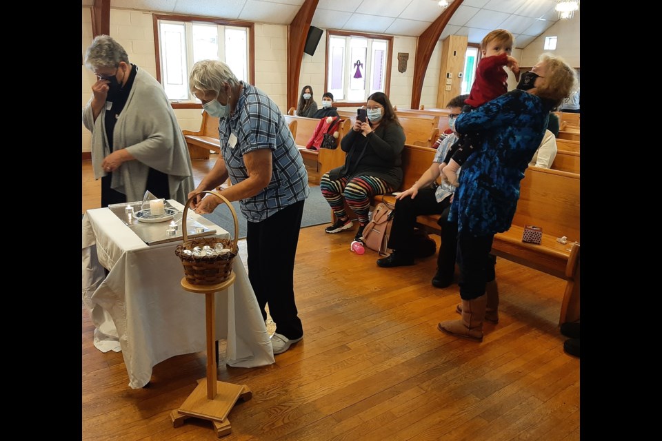 Attendees lit candles at a special Trans Day of Remembrance Service Sunday afternoon at St. David Anglican Lutheran Church in Orillia.