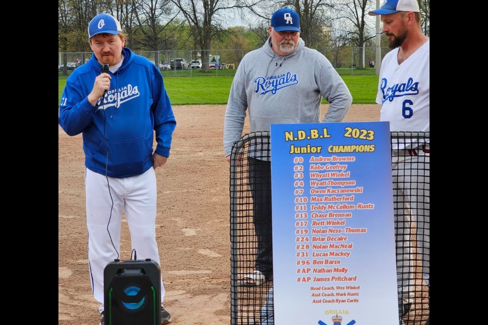 The Orillia Royals unveiled their championship banner prior to their home opener Thursday night. From left are team coach Wes Winkel, Ed Novosky, the director of rep baseball for Orillia Legion Minor Baseball and Jack Brennan, main sponsor and representative of Wes Brennan construction.