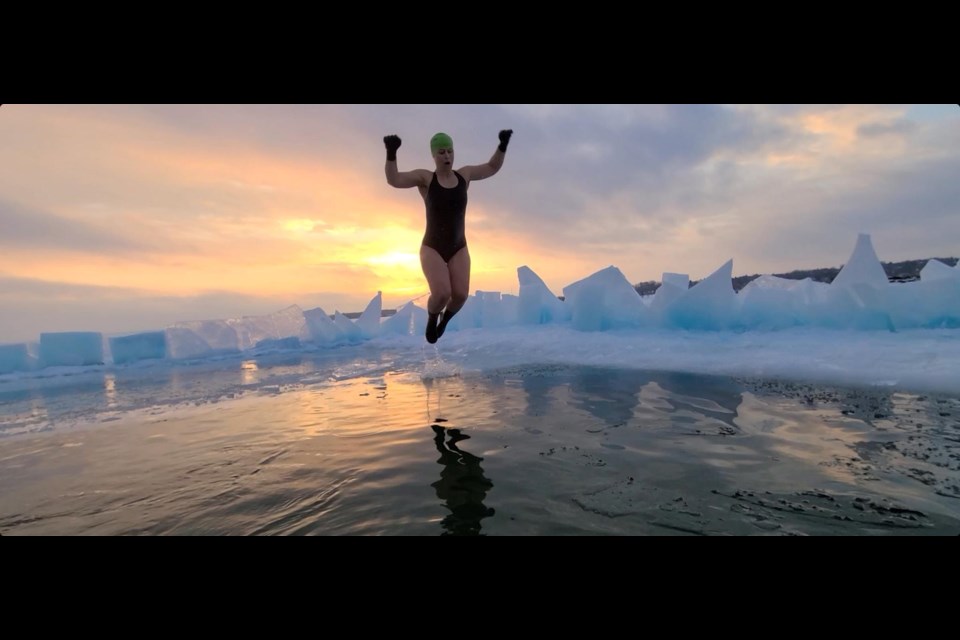 Ice swimmer Melanie Van Pypen is seen jumping into icy Kempenfelt Bay at sunrise in the winter.