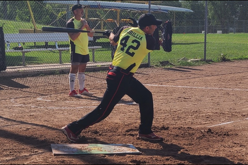 Chris Beelik, of the Orillia National Nutrition senior softball team, hits a home run during a recent game.