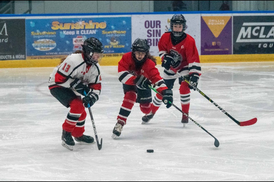 Orillia Hawks' U13 forward Emily Taylor battles for the puck during tournament action on Friday afternoon as the 29th annual Orillia Hawks tournament began at Rotary Place.