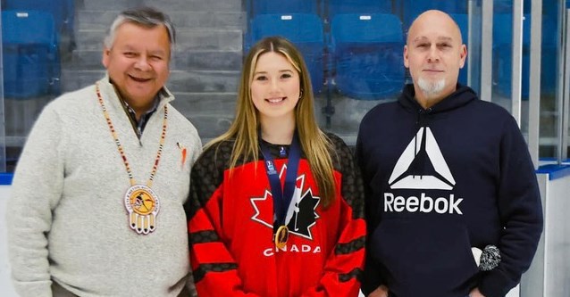 Sydney Sawyer, of Rama First Nation, shows the gold medal she won while playing a key role for Canada, which won the world U18 hockey championship recently in Finland. Sawyer is flanked by Rama First Nation Chief Ted Williams, and Terriers owner/general manager Andrew McDonald.