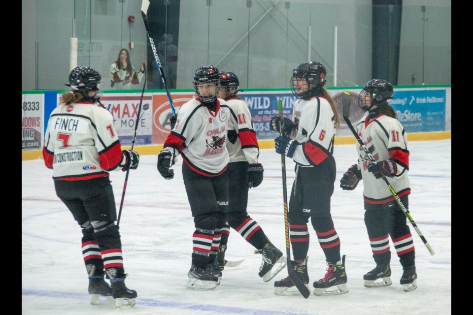 The Orillia Hawks U15B team celebrates Lillian Tolton's goal during tournament action against the Etobicoke Dolphins on Saturday morning.