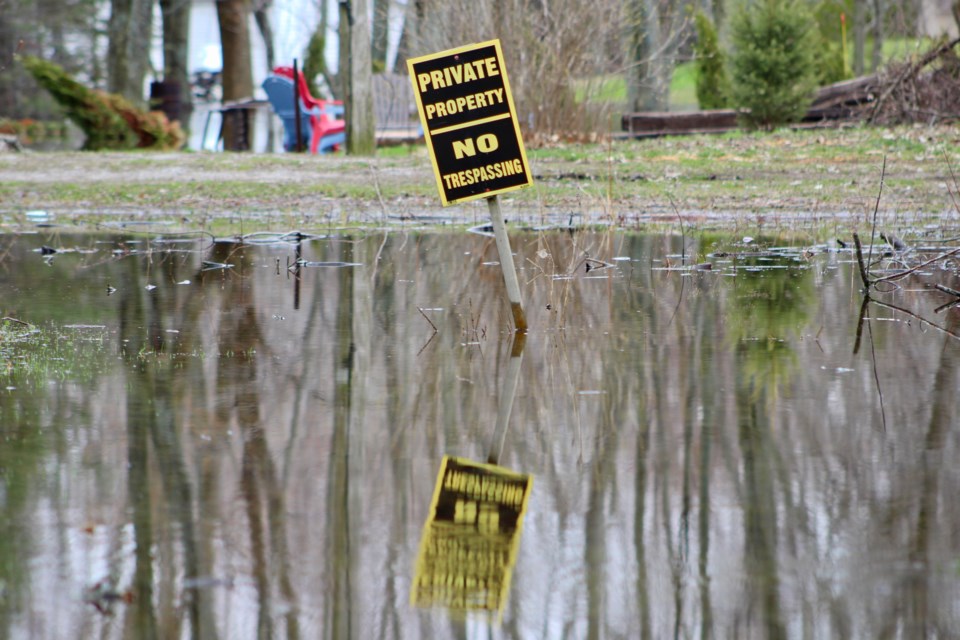 Lake St. John showed no regard for this sign on a Bluebird Street property in Ramara earlier this month. Nathan Taylor/OrilliaMatters