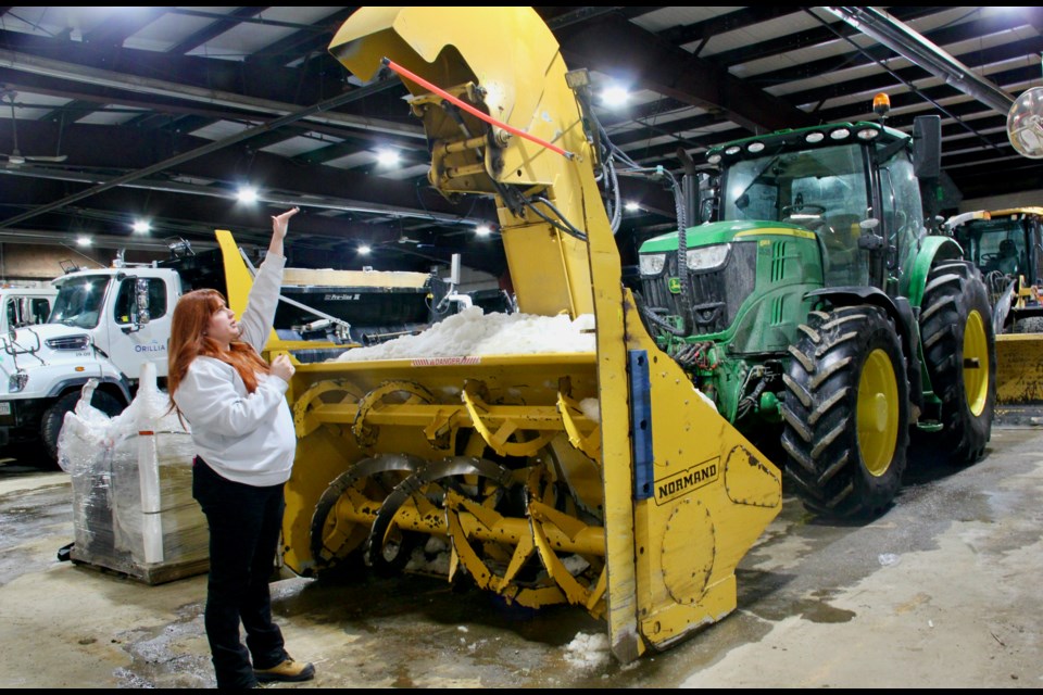 Mikaela Mahoney, manager of fleet for the environment and infrastructure services department with the City of Orillia shows the largest snowblower in the fleet.