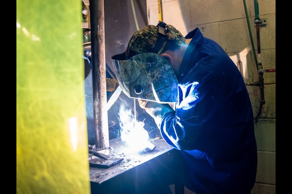 A student welds metal in Niagara College’s School of Trades lab