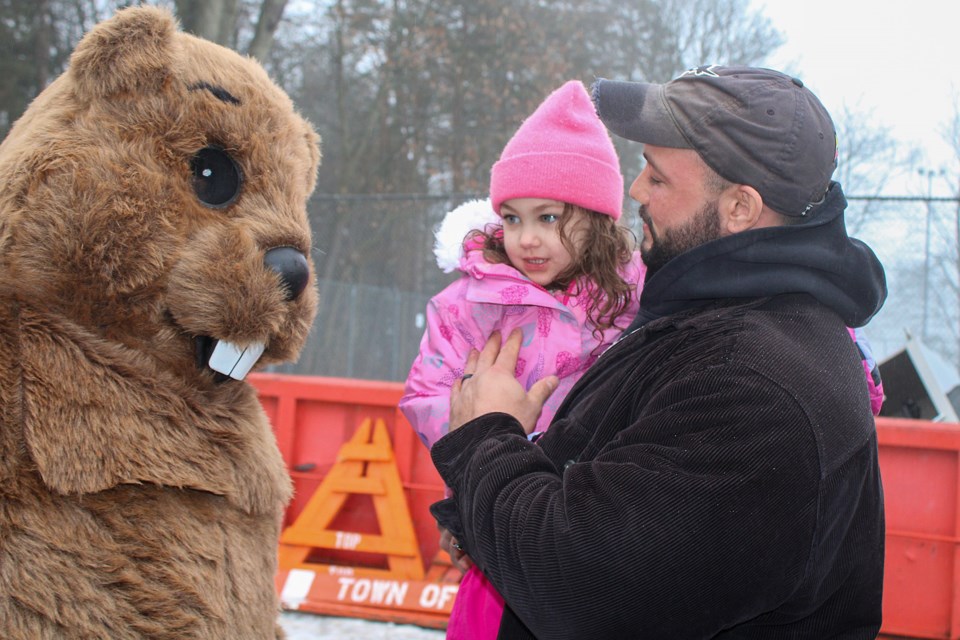 Lorean Moore, centre, and her dad, Delvin, meet Fenwick Flossie Friday. Fenwick’s favourite weather prognosticating groundhog boldly predicted an early spring after she did not see her shadow after emerging from her burrow at Centennial Park.