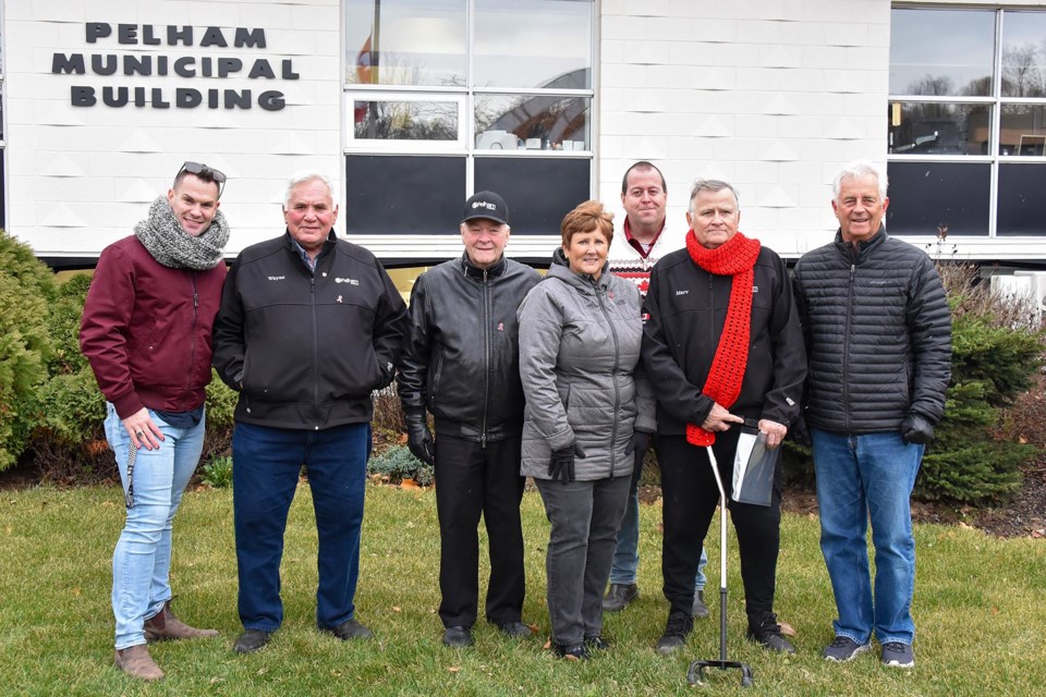 Darryl Dyball, community development and education co-ordinator for Positive Living Niagara, with Pelham Councillors Wayne Olson, Brian Eckhardt, Shellee Nisnik, CAO David Cribbs, Mayor Marvin Junkin, and Councillor John Wink at Monday’s flag-raising ceremony for HIV/AIDS Awareness Week.