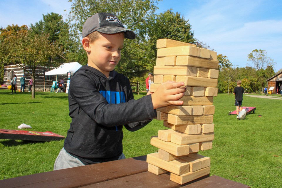 It took a steady hand, but Nolan Ryland of Niagara Falls successfully removed a block from Jenga tower, one of several free games for kids at the Ball’s Falls Thanksgiving Festival in Lincoln.