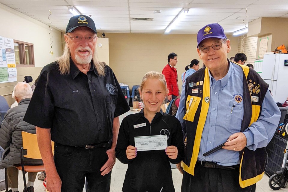 Community Partnership Manager Danielle Rosenblum receives the Fenwick Lions' donation cheque.