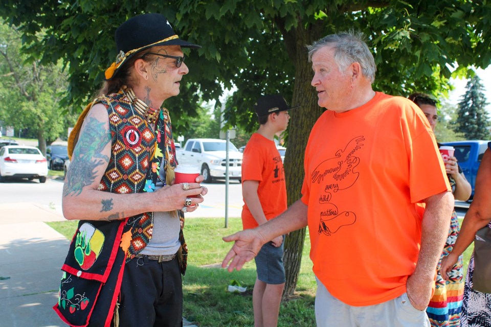 Rick Langlois speaks to Mayor Marvin Junkin after a flag raising at Town Hall to mark National Indigenous Peoples Day. Langlois, who is Anishinaabe, talked about a confrontation he experienced with a group of attendees at Summer Chill on Thursday which wound up with racist slurs being hurled toward Langlois by members of the group.