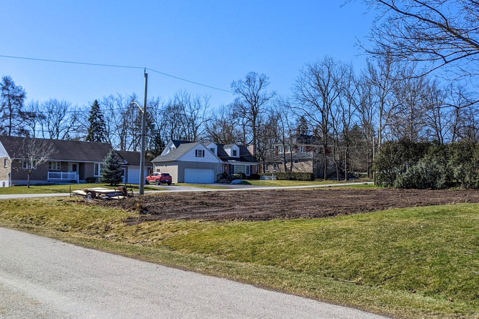 A house on Mayfair Ave. destroyed by fire last November has been razed, leaving the lot empty.