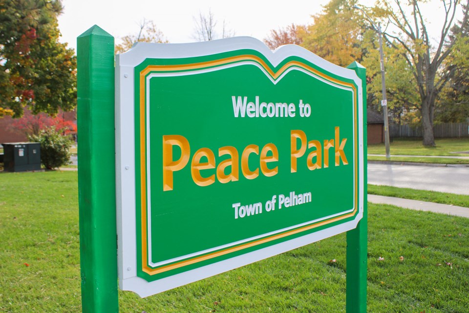 Signs at Town parks feature simplistic gold and white writing on a bright green background. 
