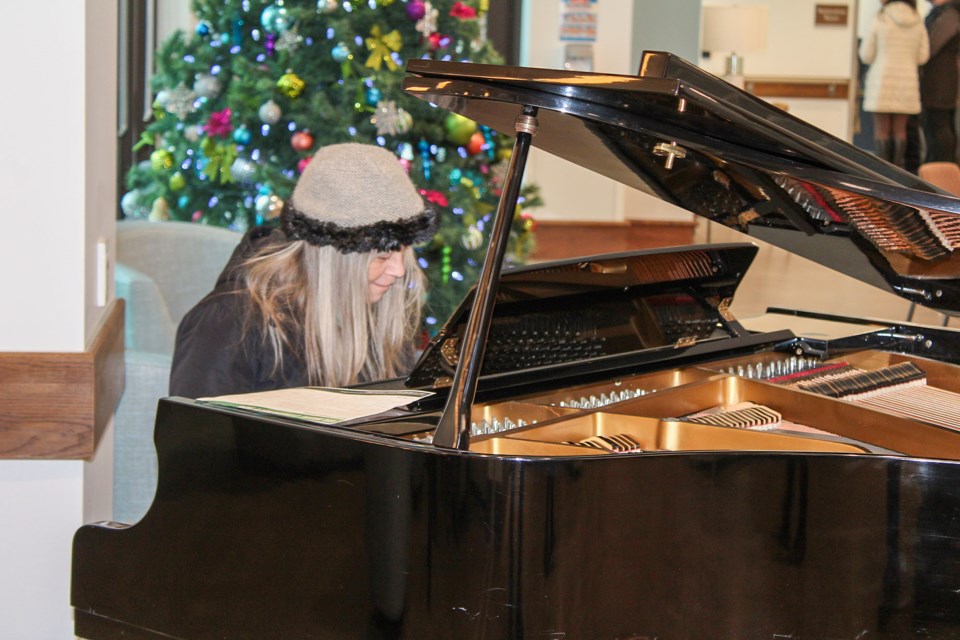 Teresa Ryley of Fort Erie stopped to play a song on the piano located in the lobby at the new Gilmore Lodge in Fort Erie.