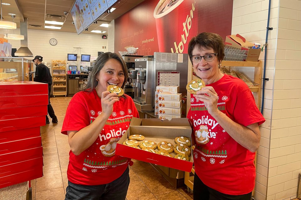 Stephanie McWilliams, co-owner of Tim Hortons Fonthill locations, shares a box of Holiday Smile Cookies will Pelham Cares’ board member Lori Grande. Fifty per cent of the Proceeds from the sales of the cookies will go to Pelham Cares to help support the agency’s programs.