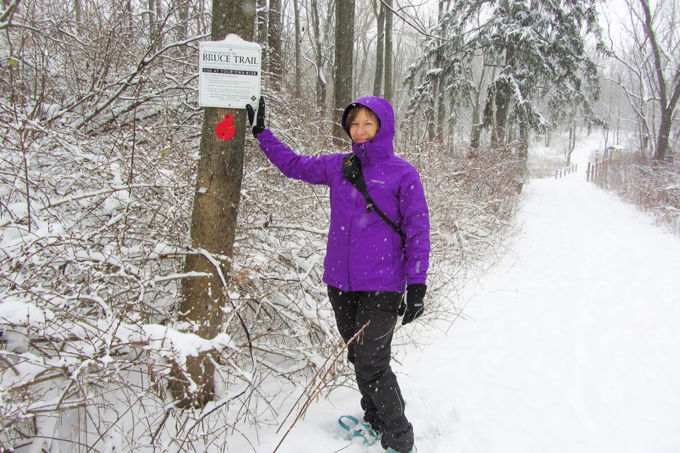 The entrance to Swazye Falls from the Cataract Road parking lots is easily accessible along the Bruce Trail in winter with or without specialized footwear, as Els Swart happily demonstrates.