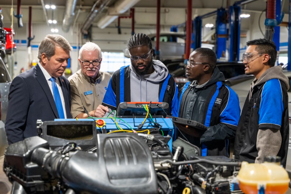 MP Vance Badawey, motive power program coordinator Wayne Toth, and students in the Green Automotive Technology Lab at NC’s Welland Campus.