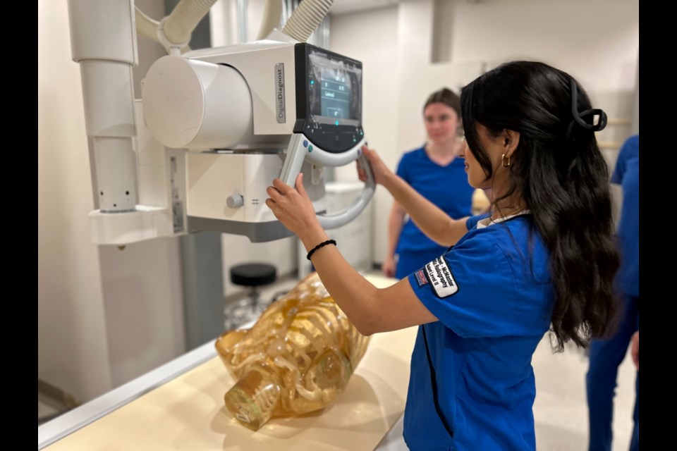 Medical Radiation Sciences student demonstrates the use of medical scanning equipment at Mohawk College’s Institute for Applied Health Sciences campus.