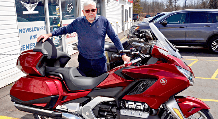 John Clare with a Honda Gold Wing touring bike. | Don Rickers