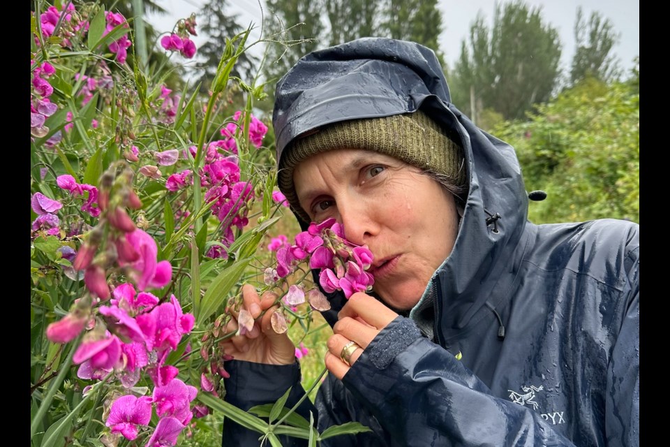 Whistler painter Alli van Gruen stops to smell some flowers.