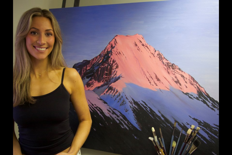 Whistler-based artist Cassie Dickinson and one of her paintings. 