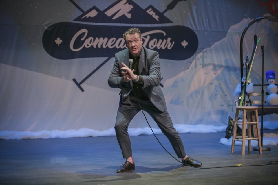 Dan Quinn, founder of the Snowed In Comedy Tour, performs onstage.