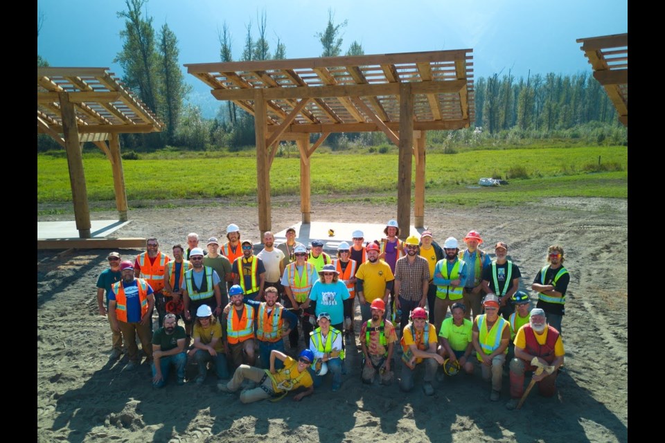 Volunteers pose for a group photo at the site of a new powwow arbour near Mount Currie and Pemberton.