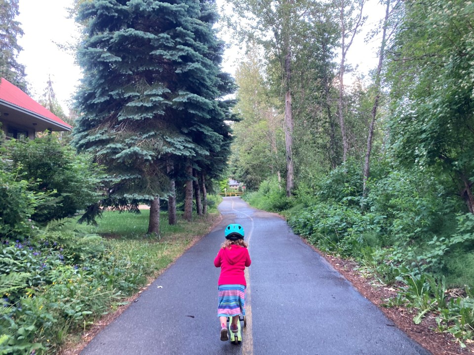 ellie-harding-rides-a-scooter-on-the-valley-trail-wearing-a-helmet-taken-by-robert-wisla