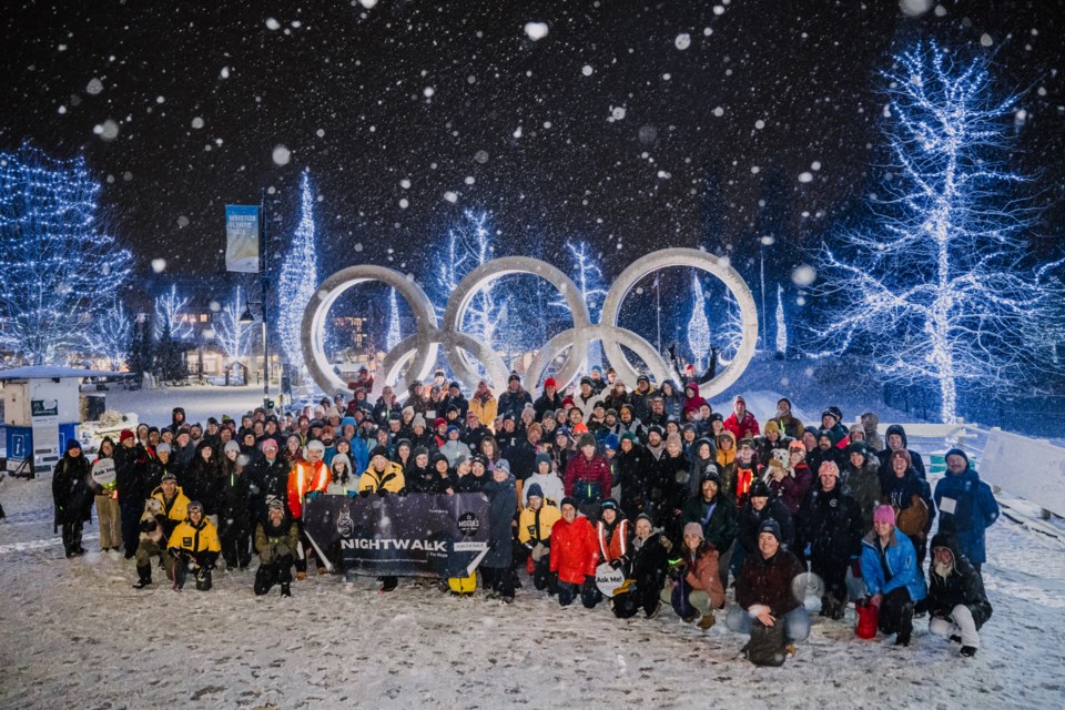 Attendees of Nightwalk for Hope gather for a photo at Whistler's Olympic Rings.