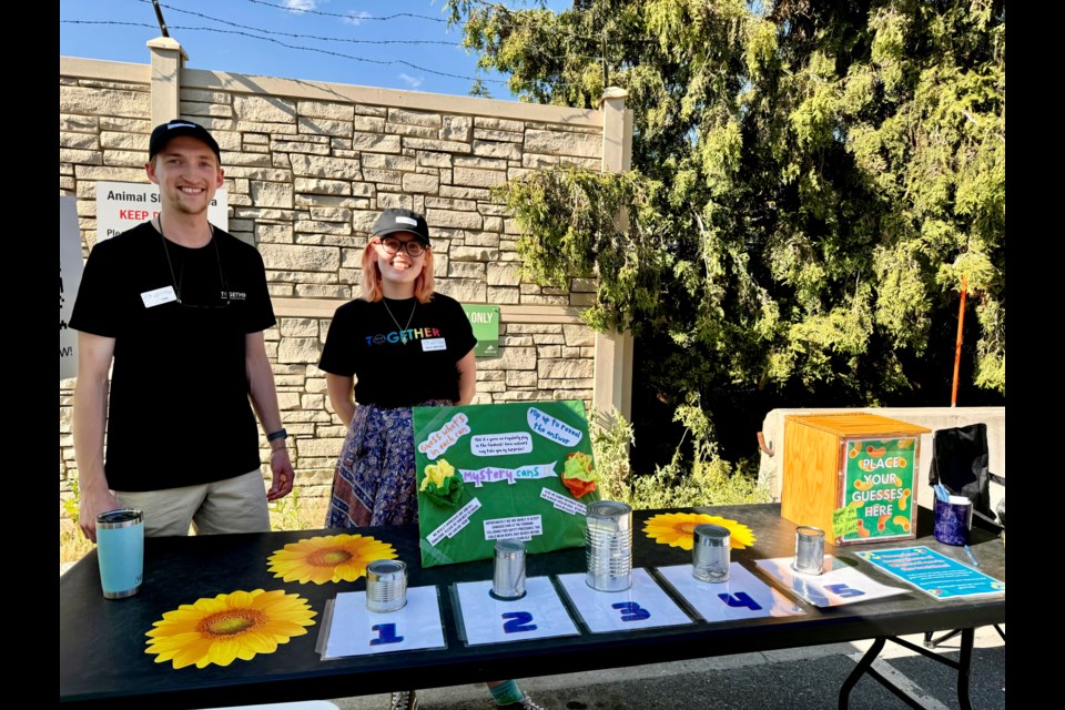 WCSS staff Tom Chatwood (left) and Holly Watkins (right) man a games booth during the birthday party.