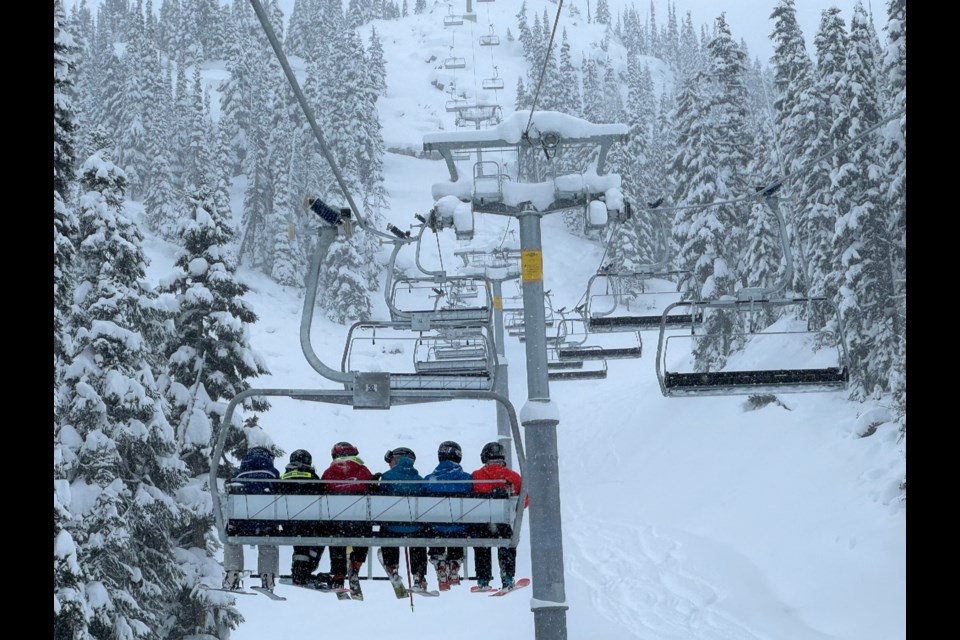 Skiers riding up the first chair of Jersey Cream on Blackcomb Mountain.