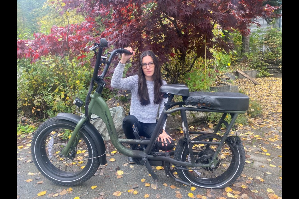 Samantha Roberts with the remains of her RadRunner 2 Utility e-bike. 