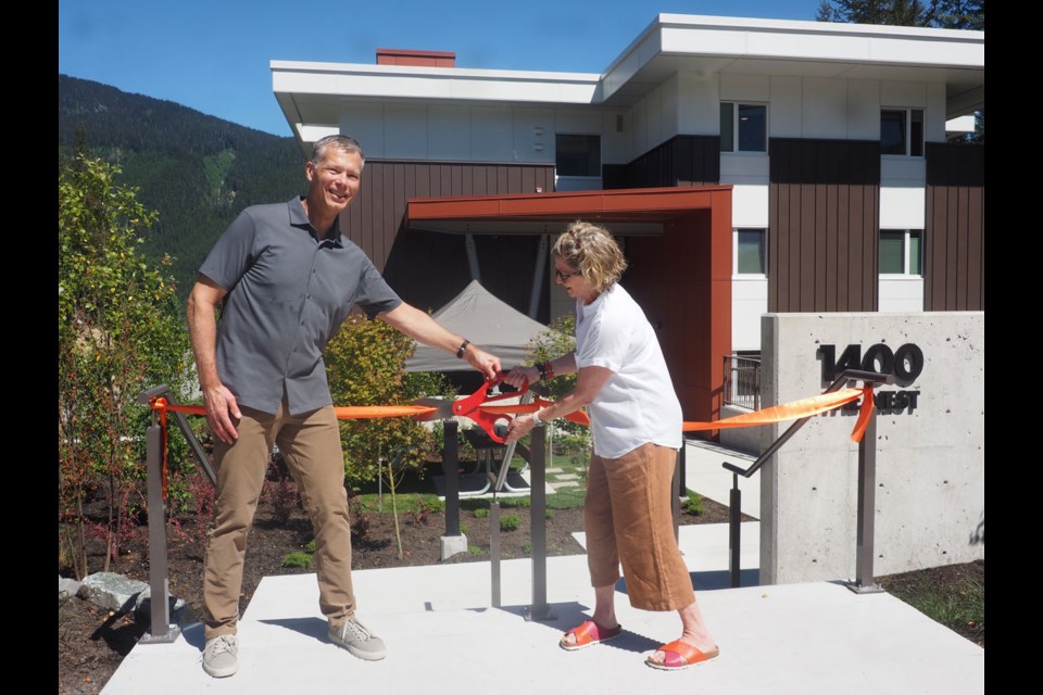 HOUSE AND HOME John Morley of the Whistler 2020 Development Corp and Cathy Jewett of the Whistler Valley Housing Society cut the ribbon on 30 new units of rental housing in Cheakamus on July 5. “The Nest,” as it’s called, is already nearly fully occupied. 