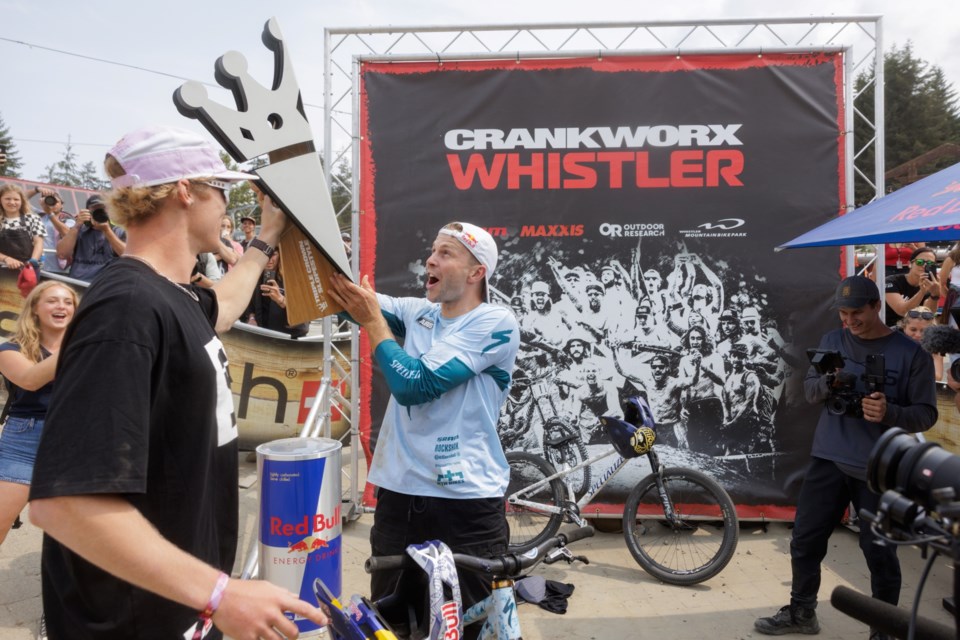 Dawid Godziek (middle) receives the 2024 Slopestyle Triple Crown award from Emil Johansson (left). 