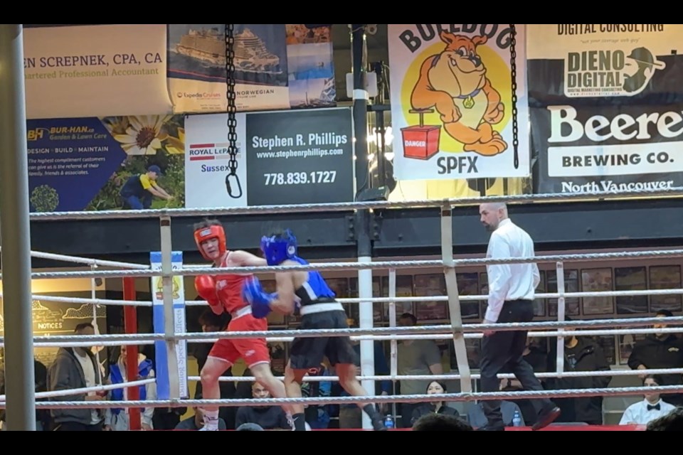 Leo Laferriere (in red) catches Arjun Mangat with a left hook at Griffins Boxing on Feb. 21, 2025.