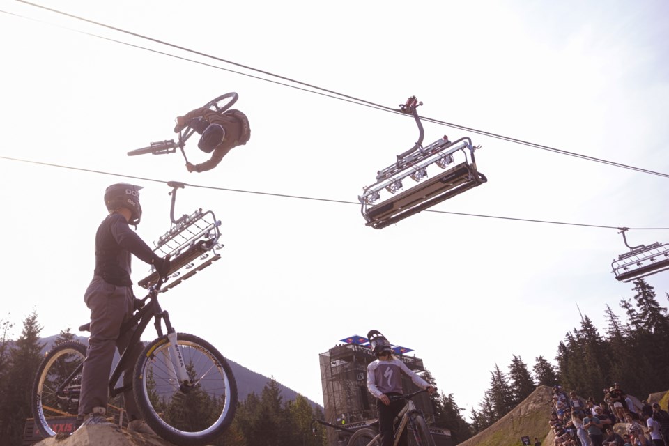 Lukas Skold goes airborne at the 2024 Red Bull Joyride as two other riders look on.