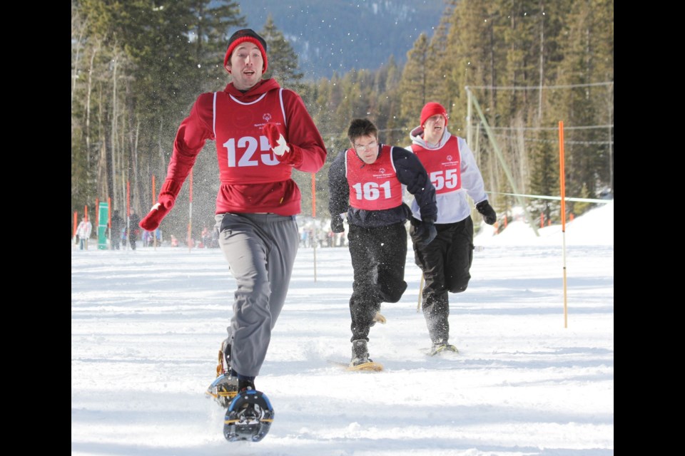 Three Special Olympics athletes participate in snowshoeing.