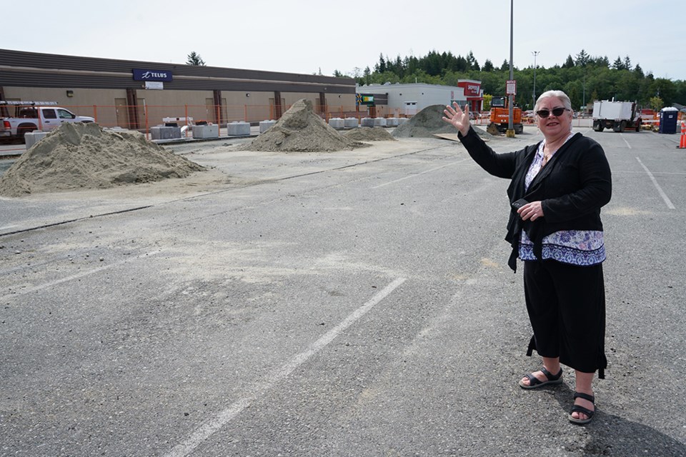  NEW LOCATION: Construction has begun on the new bus exchange on the west side of Powell River Town Centre with mall general manager Lorelei Guthrie indicating where the new four-bus platform will be built. The current bus exchange is located at the north end of the mall, but with the expansion of the BC Liquor store and new mall tenant Winners going in, there is no space in the current location for buses to continue to operate from that area.                              
