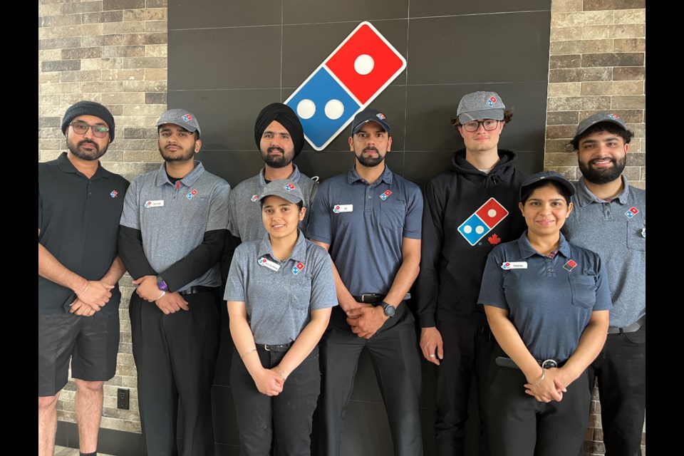 HAPPY CREW: Franchise owner at Dominos Pizza Gurpreet Sidhu [left] and crew work hard to make and deliver pizza to qathet residents.

