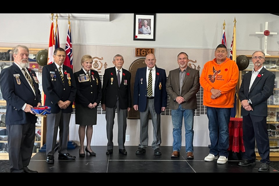 PREMIERE POPPY: The first poppy ceremony took place on Wednesday, October 25, inside Royal Canadian Legion (RCL) Branch 164. Assembled on stage [from left] were local poppy committee members Chris Carnell and Bill Demkiw; past president of BC/Yukon command Val McGregor; Canadian WWII veteran and legion member Ted Lloyd; former Branch 164 president Merv Byers; qathet Regional District board chair Clay Brander; Tla’amin Nation hegus John Hackett and City of Powell River councillor Rob Southcott. The ceremony brings together civic leaders and the poppy committee to present the first poppy, preceding the official launch of the Poppy Campaign on Friday, October 27.