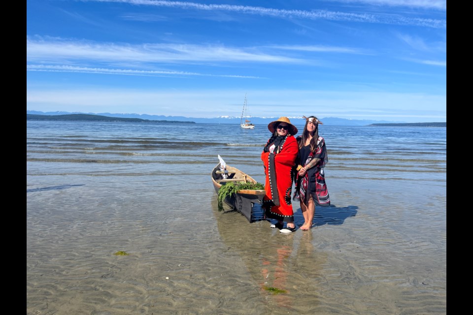 VISITOR PROTOCOL: Tla'amin Nation employee Tara Tipton [left] and Tla’amin member Frankie Mcwade demonstrated visitor protocol to qathet School District students and private school students, who observed from Willingdon Beach. Today, June 21, is National Indigenous Peoples Day.
