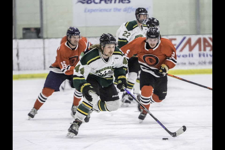 Powell River Regals' defender Jack Long skates away from a pair of Rossland Warriors during a Coy Cup senior hockey playoff game at Hap Parker Arena on February 12.