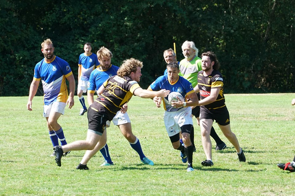 EXCITING GAME: In the feature competition of the recent Otago Rugby Club 10-a-side tournament, Otago (in blue uniforms) faced a strong Nanaimo Hornets contingent, losing the tough-fought contest by one try. The tournament has been hailed as a success and there are plans to make it an annual event, drawing in teams from out of town.                               