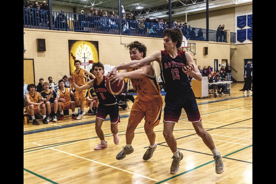 NVSS Viking Thomas Cross tries to hold on to the ball as DP Todd Trojan Logan Slater tries to force it from his grip during the AA Senior Boys Zones Basketball final game Sunday Feb 23 at DP Todd.