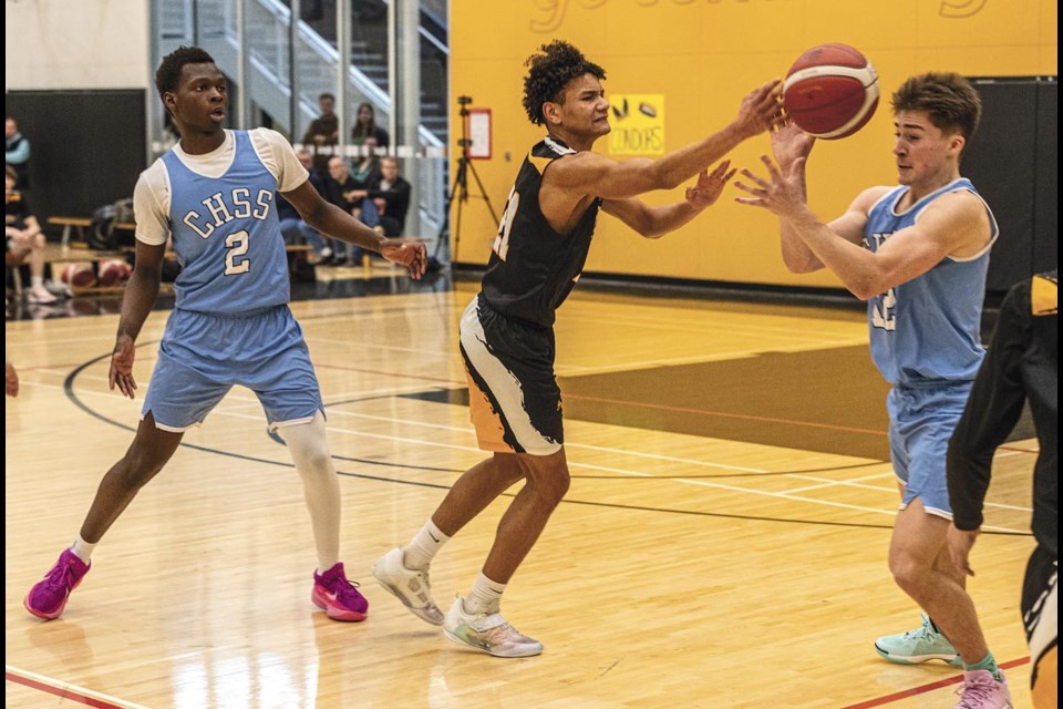 Duchess Park Condor Ismael Andrews-Cisse passes the ball through the hands of College Heights Cougar Dillon Piddocke during the triple-A North Central zone final at Duchess Park on Feb. 22, 2025