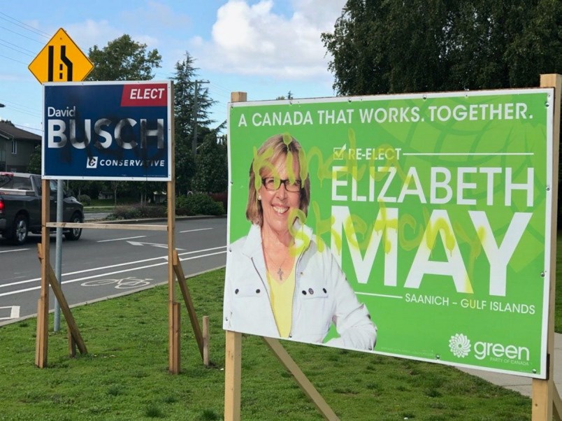 Damaged election signs promoting Green Party Leader Elizabeth May and Saanich Gulf-Islands Conservative candidate David Busch at McKenzie Avenue and Gordon Head Road in Saanich. (via Saanich-Gulf Islands Conservative campaign)