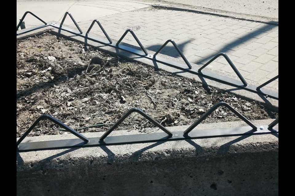 Metal triangles have been installed on flower beds on 20th avenue. 