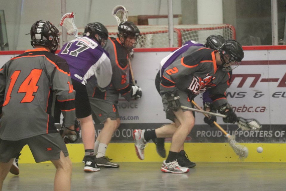 The Northland Nissan Assault and Westwood Pub Devils battle for the ball along the Kin Centre boards in the 2019 Prince George Senior Lacrosse Finals (via Kyle Balzer)